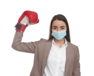 Photo of Businesswoman with protective mask and boxing gloves on white background. Strong immunity concept