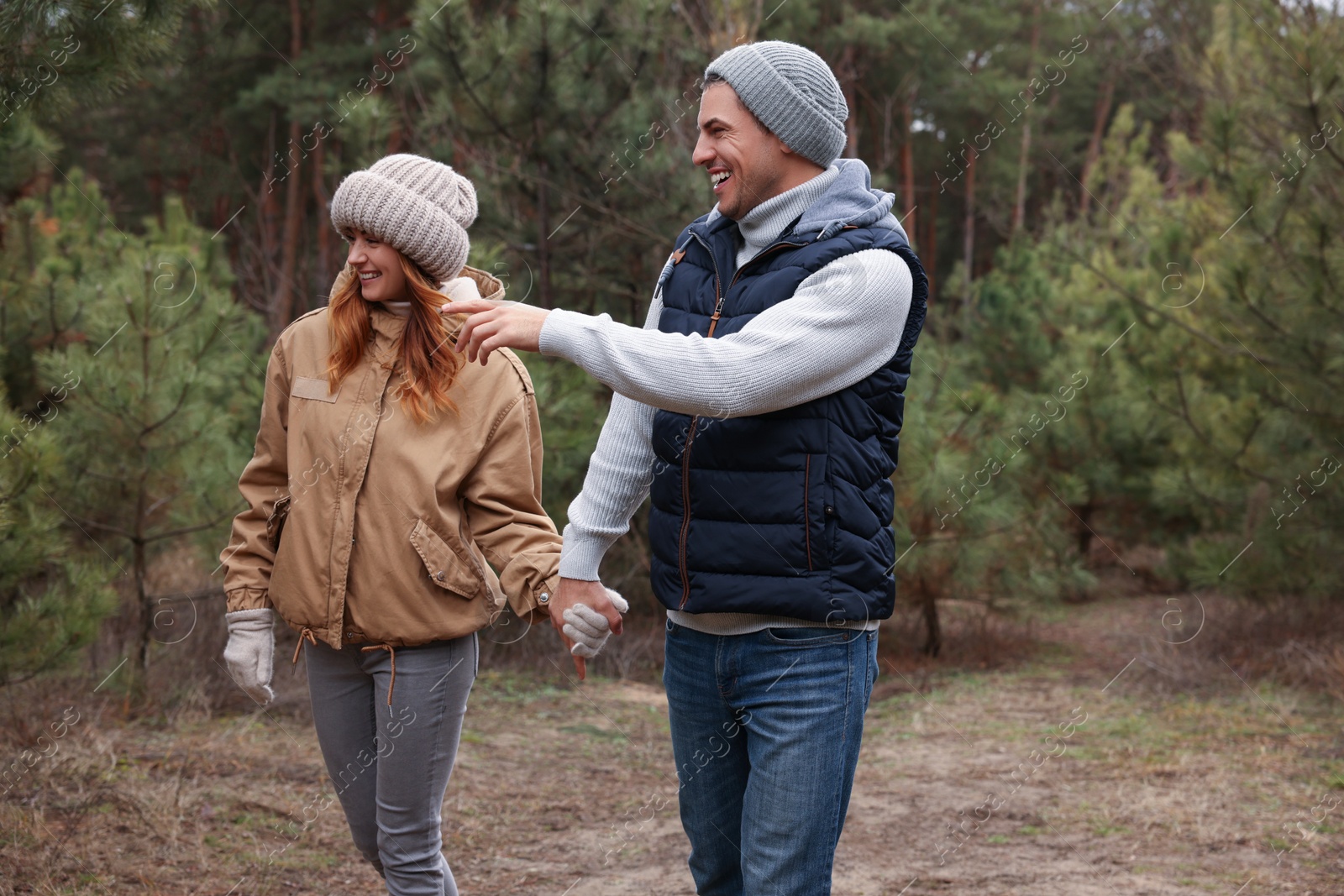 Photo of Happy couple spending time together in forest