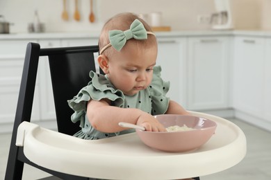 Photo of Cute little girl eating healthy food at home