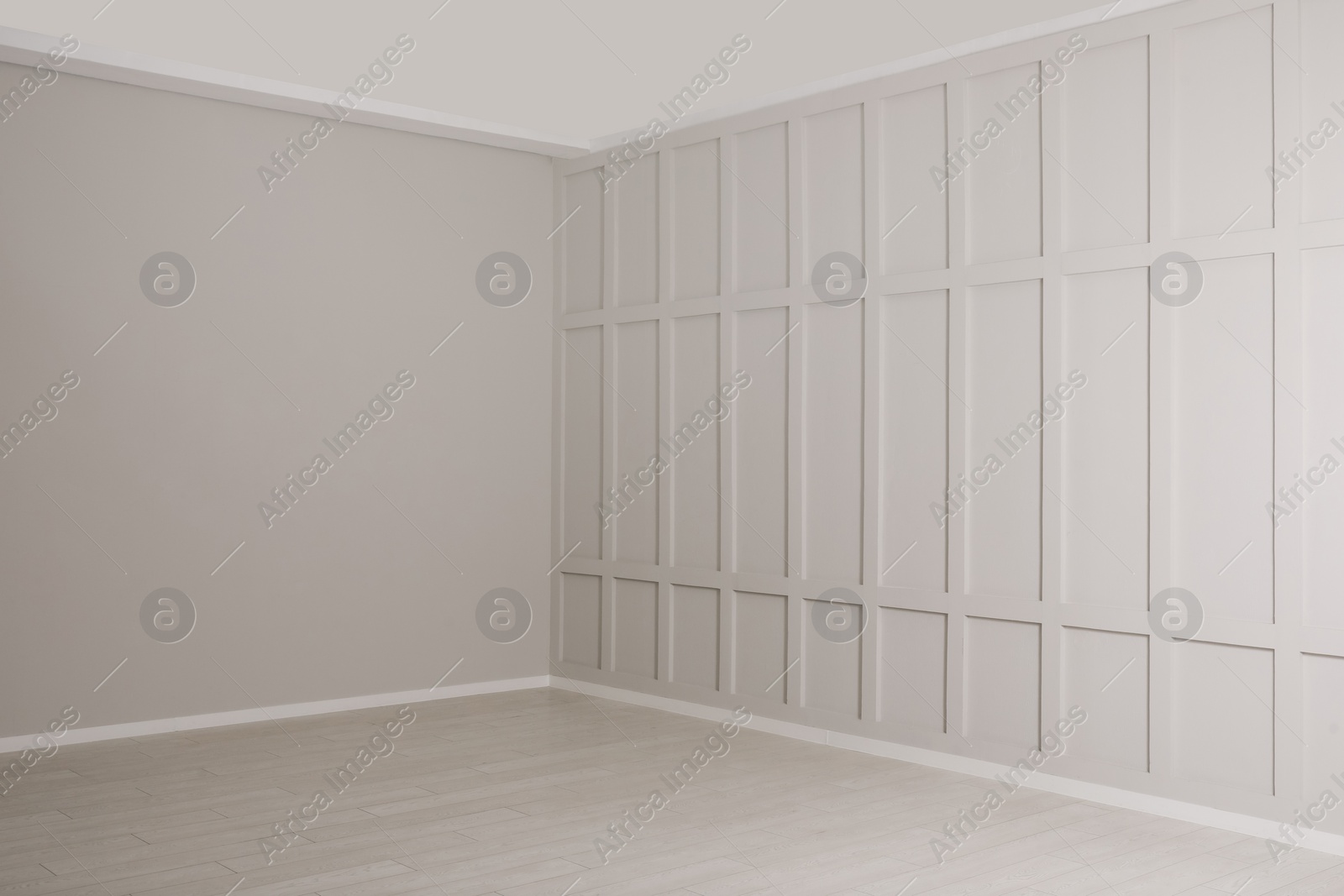 Photo of Empty room with beige walls and laminated flooring