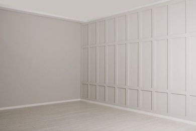 Photo of Empty room with beige walls and laminated flooring