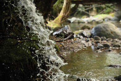 Photo of Picturesque view of mountain waterfall, closeup. Space for text