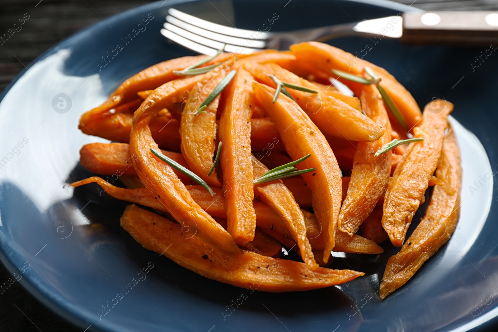 Photo of Closeup view of plate with tasty sweet potato fries