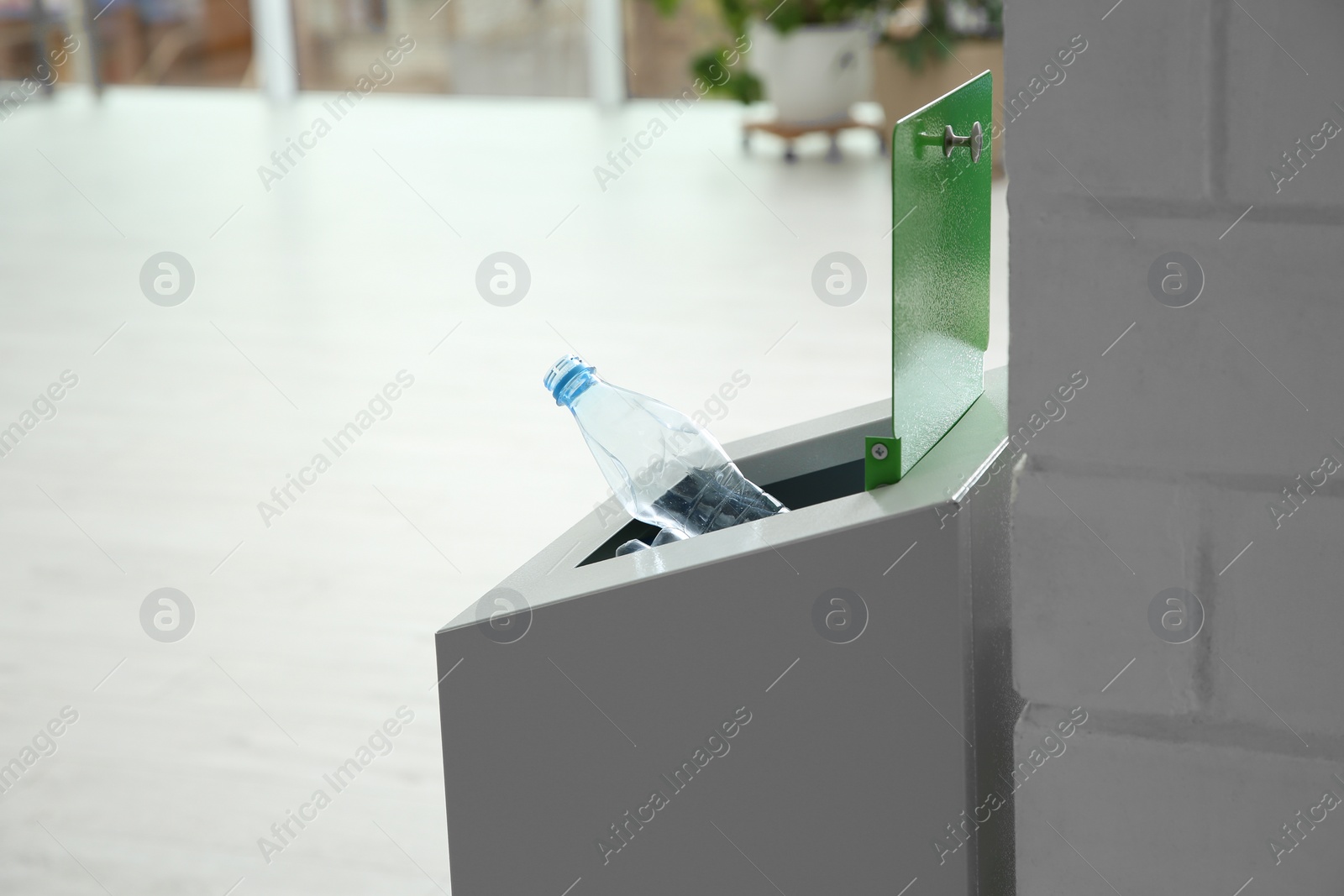 Photo of Metal bin with garbage indoors, space for text. Waste recycling