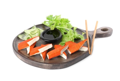Photo of Fresh crab sticks with lettuce and soy sauce on white background