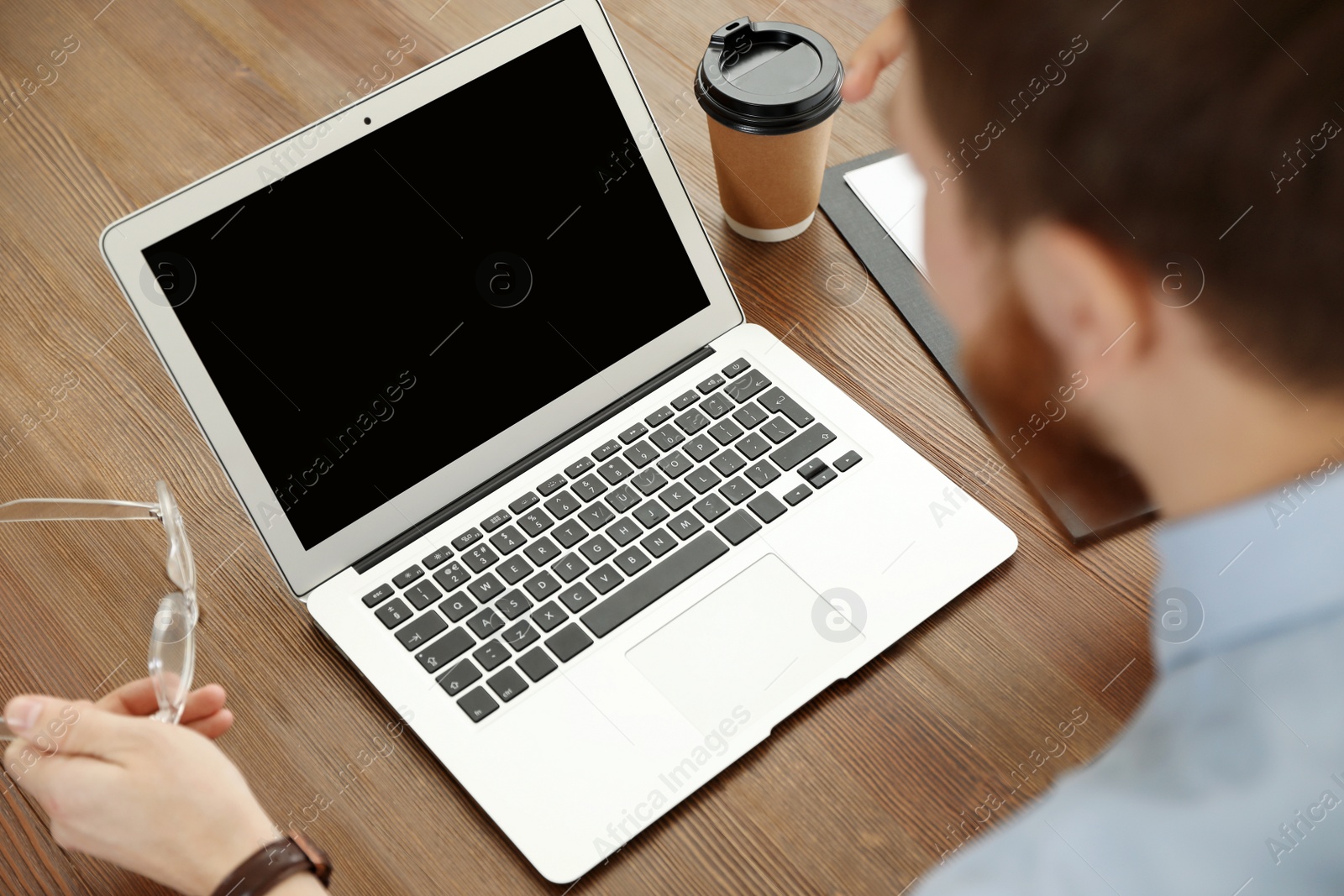 Photo of Man using video chat on laptop in home office, closeup. Space for text