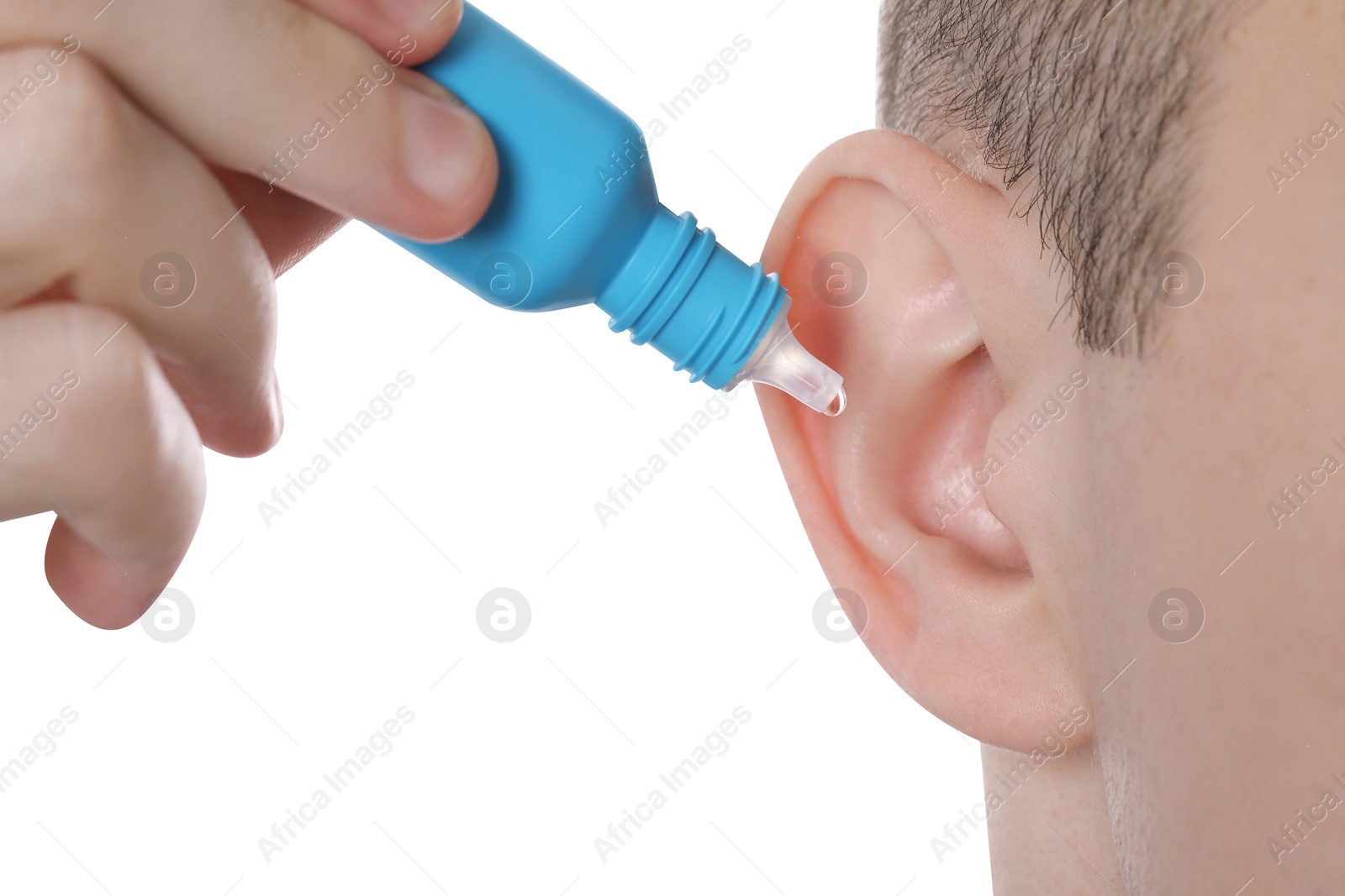 Photo of Man using ear drops on white background, closeup