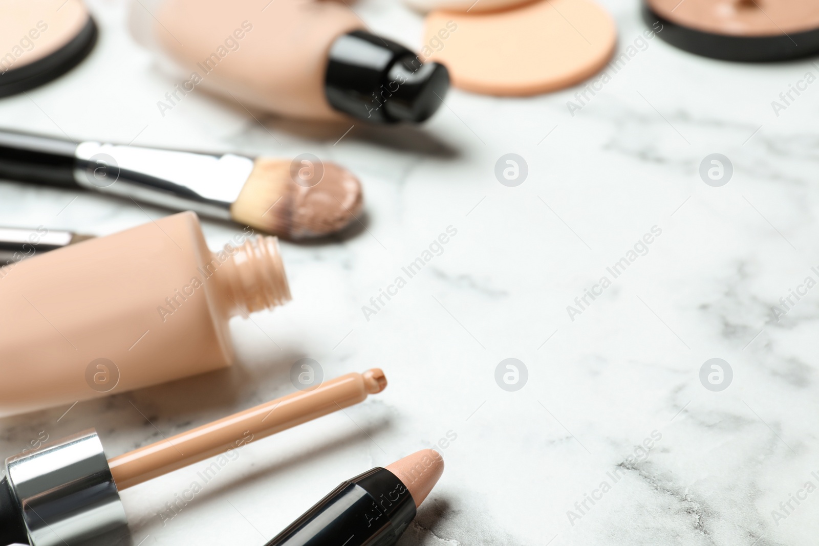 Photo of Composition with skin foundation and beauty accessories on marble background. Space for text