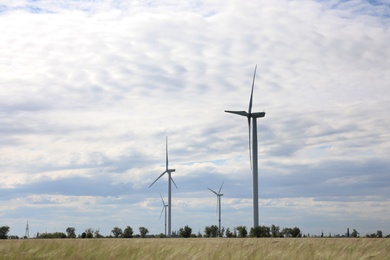 Photo of Beautiful view of field with wind turbines. Alternative energy source