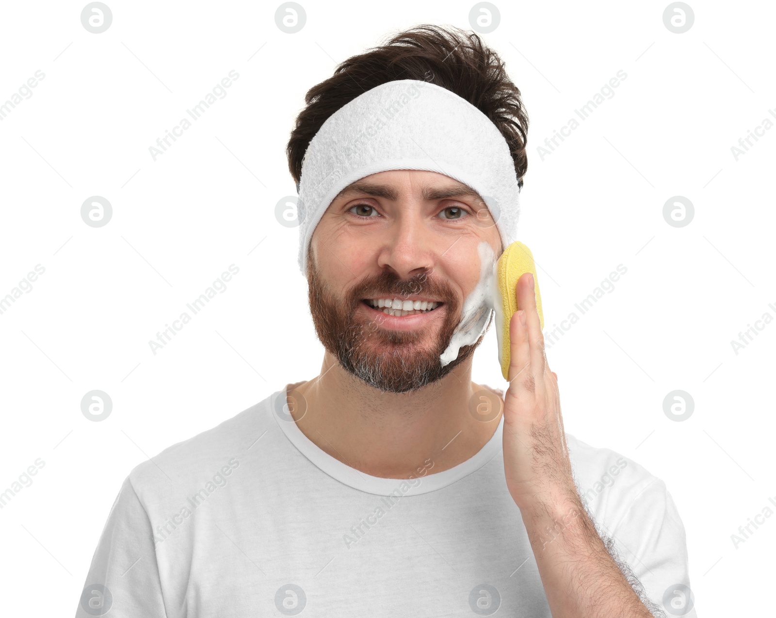 Photo of Man with headband washing his face using sponge on white background