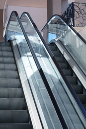 Modern escalators with handrails in shopping mall