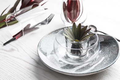 Elegant table setting with floral decor on white wooden background