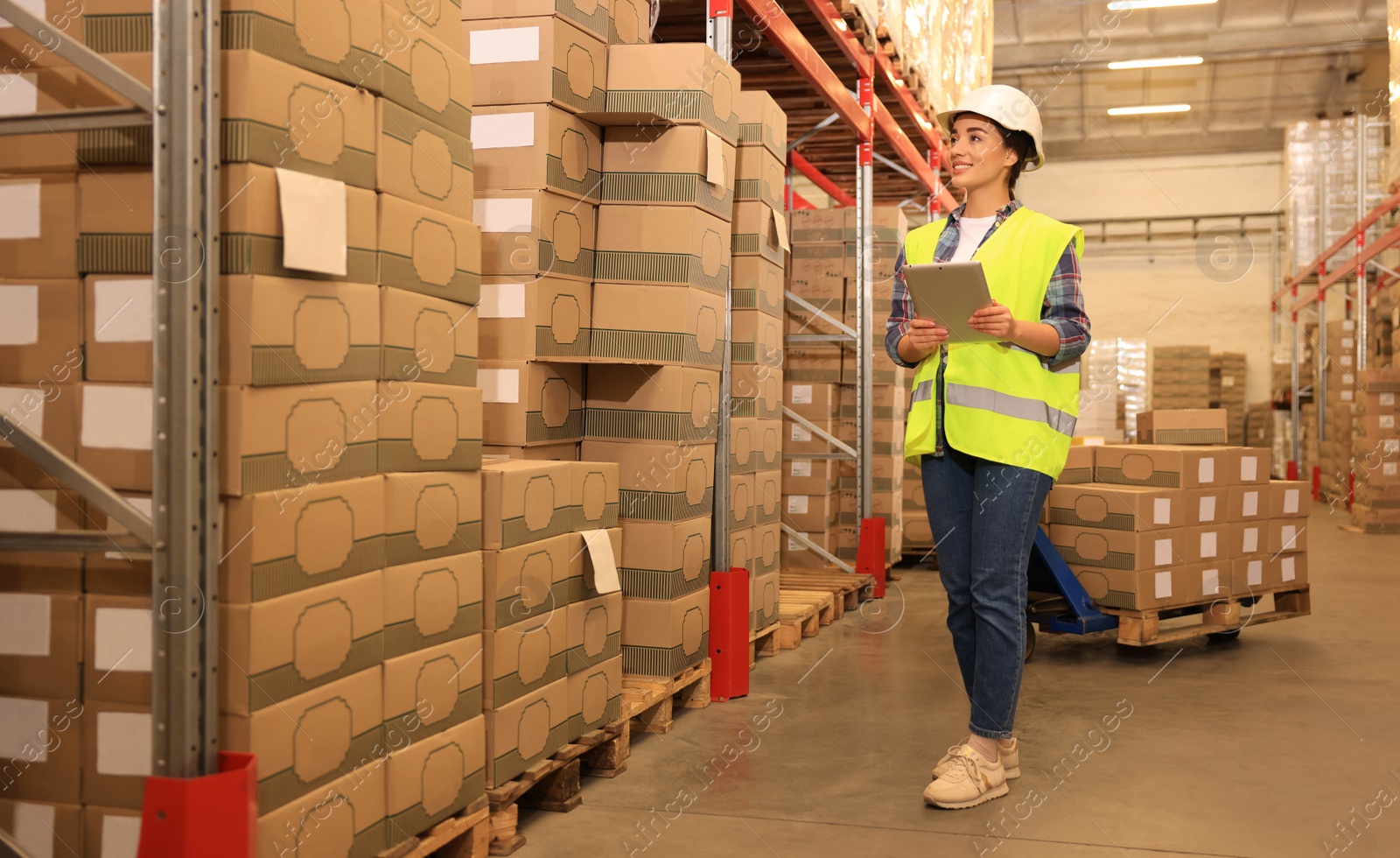 Image of Woman with tablet working at warehouse. Logistics center