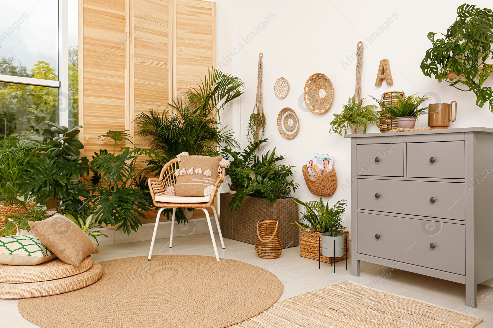 Photo of Room interior with stylish furniture and green plants