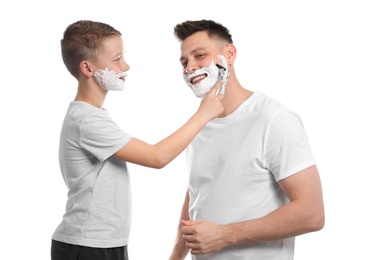 Photo of Son shaving his dad with razor isolated on white