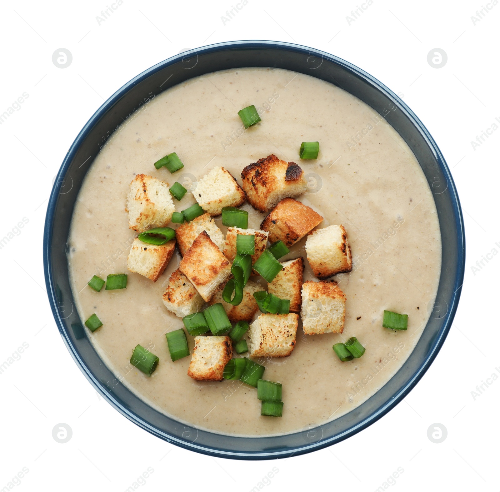 Photo of Bowl of fresh homemade mushroom soup on white background, top view