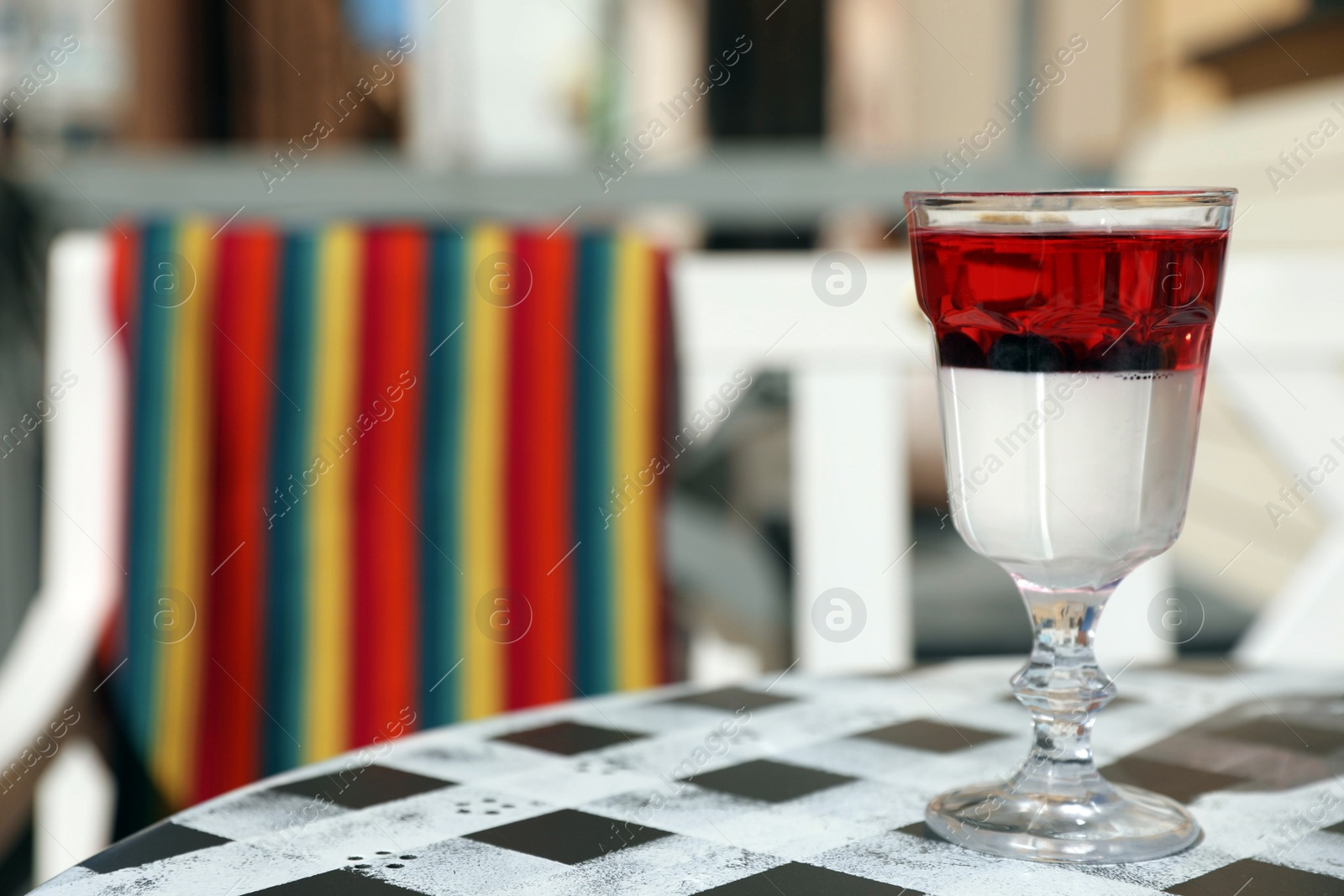 Photo of Delicious panna cotta dessert on table in cafe. Space for text