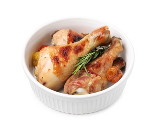 Photo of Delicious roasted chicken drumsticks with rosemary and tomatoes in bowl isolated on white