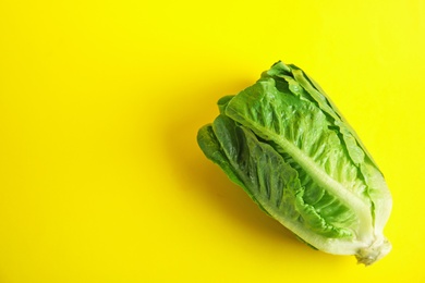 Photo of Fresh ripe cos lettuce on color background