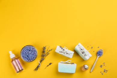 Photo of Flat lay composition with natural handmade soap on yellow background. Space for text