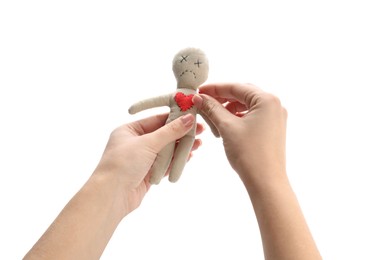 Photo of Woman stabbing voodoo doll with pin on white background, closeup