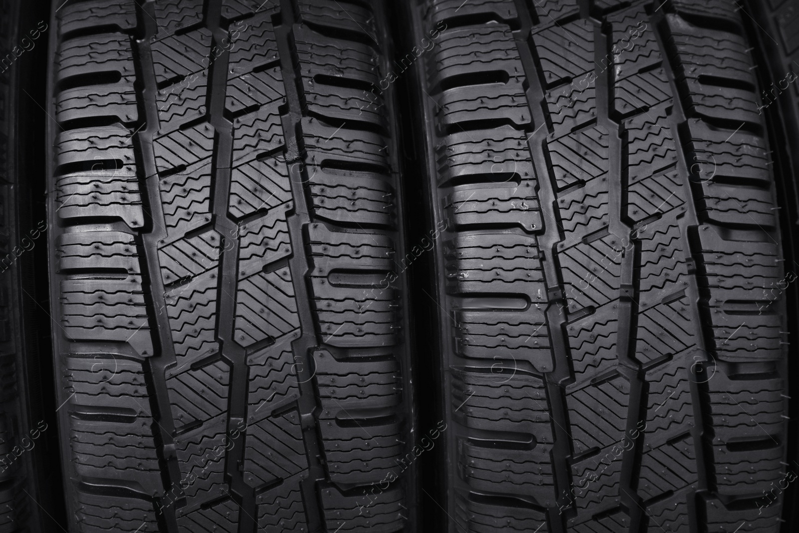 Photo of Car tires as background, closeup. Auto store