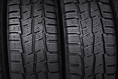 Photo of Car tires as background, closeup. Auto store