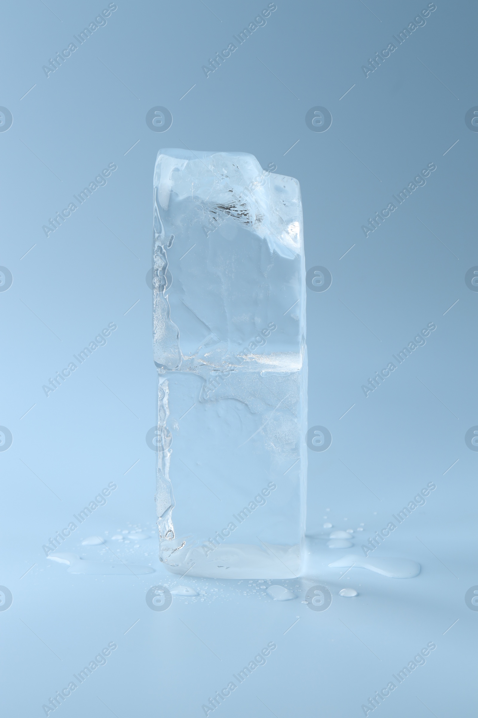 Photo of Blocks of clear ice on light blue background