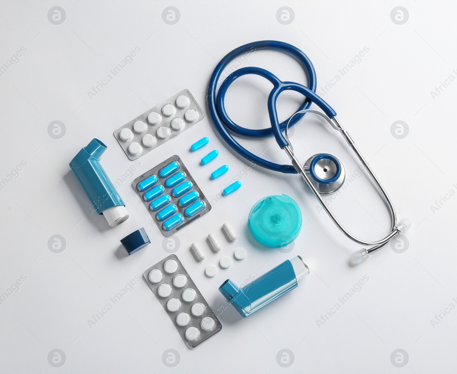 Photo of Flat lay composition with stethoscope and asthma medications on white background