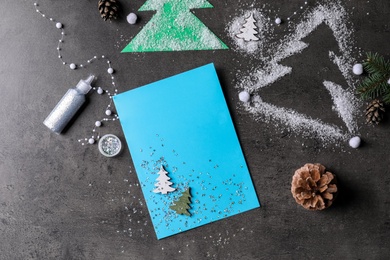 Photo of Beautiful Christmas card and decor on black table, flat lay