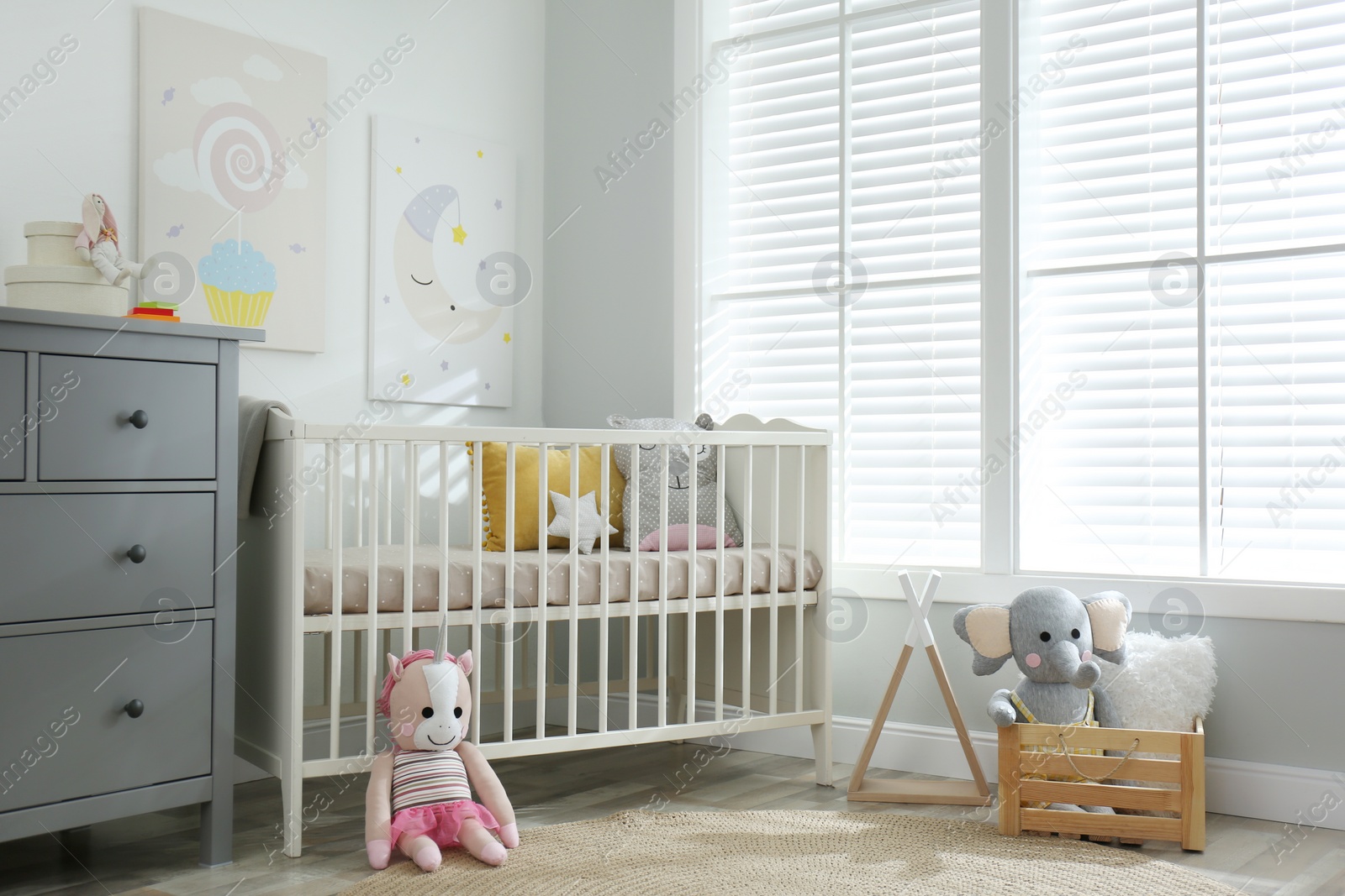 Photo of Baby room interior with cute posters and crib