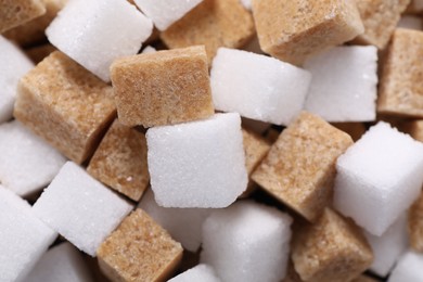 Photo of White and brown sugar cubes as background, closeup