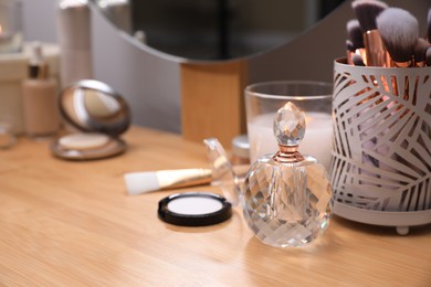 Photo of Different decorative cosmetic products on dressing table