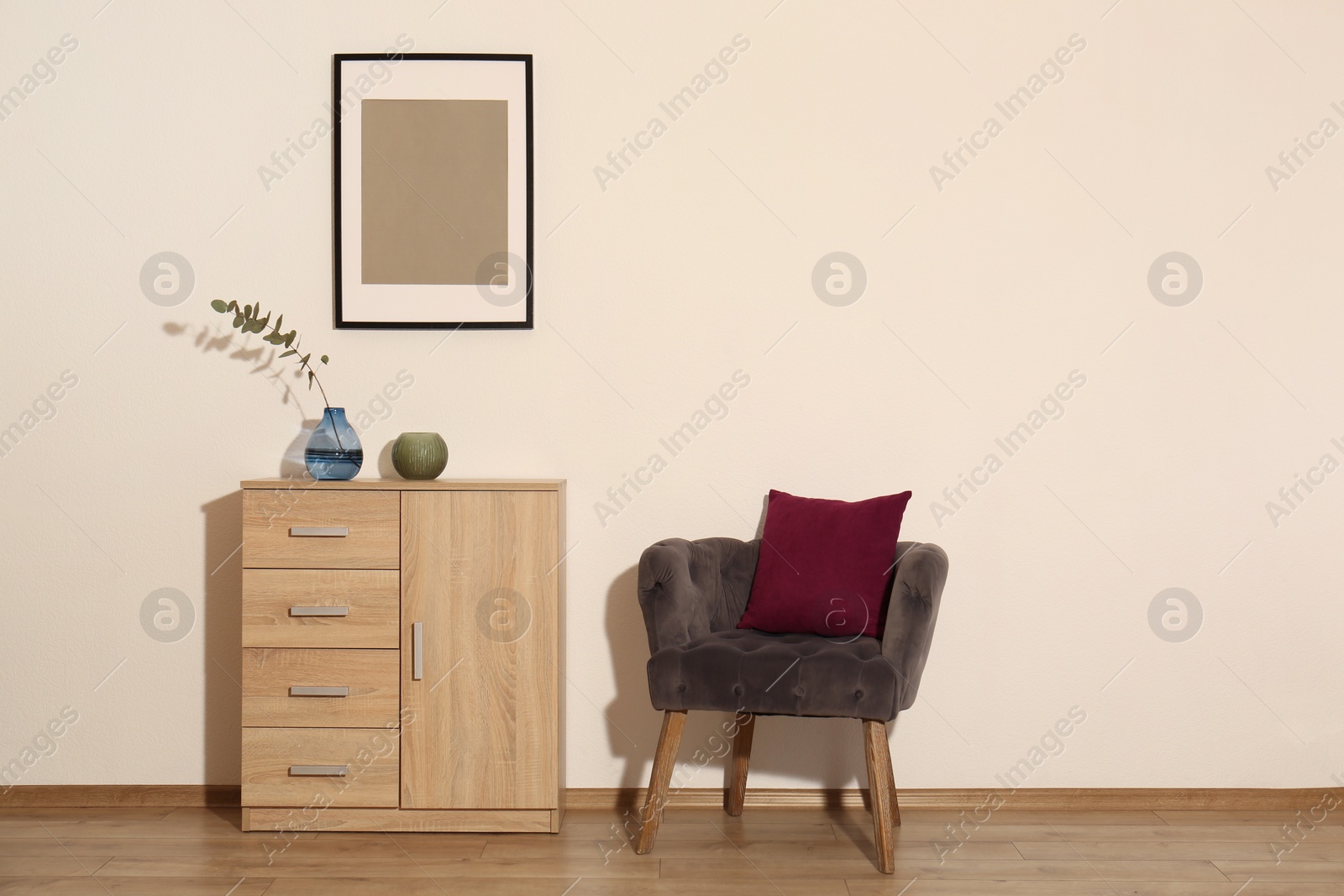 Photo of Room interior with armchair and wooden cabinet