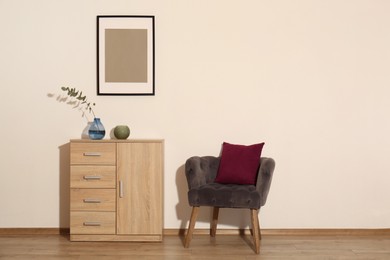 Room interior with armchair and wooden cabinet