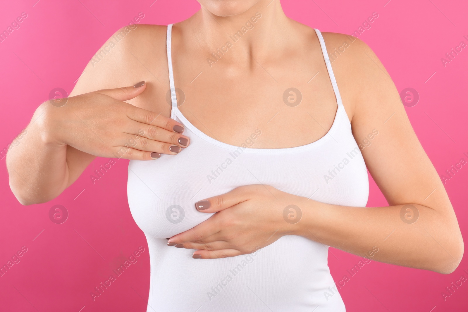 Photo of Woman checking her breast on color background, closeup