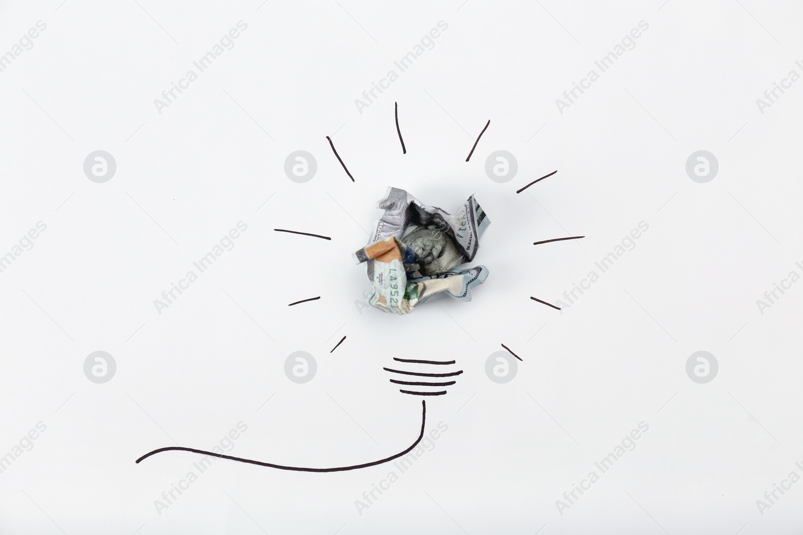 Photo of Composition with crumpled banknote and drawing of lamp bulb on white background, top view. Creative concept