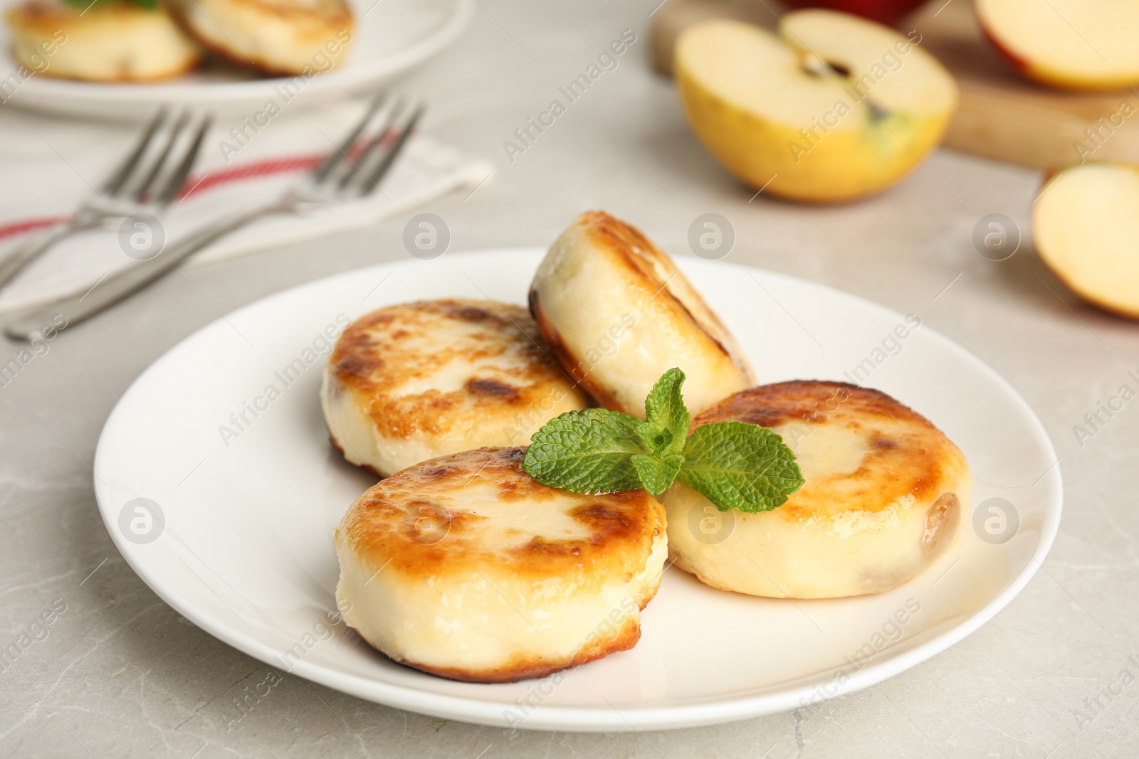 Photo of Delicious cottage cheese pancakes with mint on table