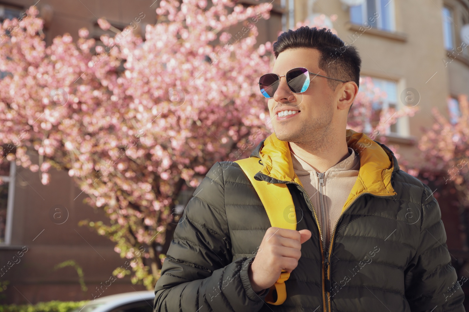 Photo of Happy male tourist sightseeing outdoors on spring day