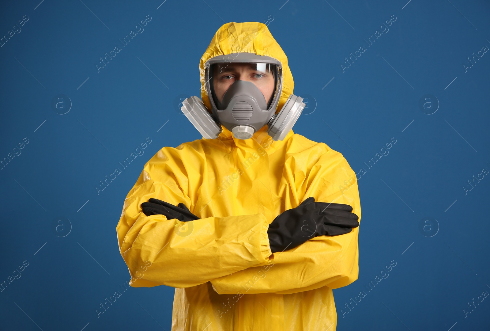 Photo of Man wearing chemical protective suit on blue background. Virus research