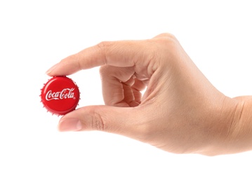 Photo of MYKOLAIV, UKRAINE - NOVEMBER 15, 2018: Woman holding Coca Cola lid on white background