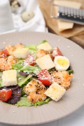 Photo of Delicious Caesar salad with shrimps on white table, closeup