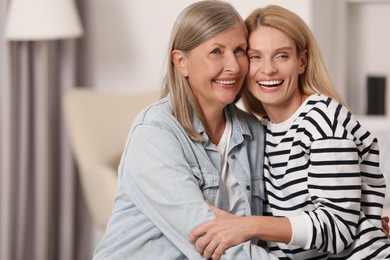 Photo of Happy mature mother and her daughter at home