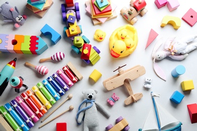 Photo of Different toys on light background, flat lay