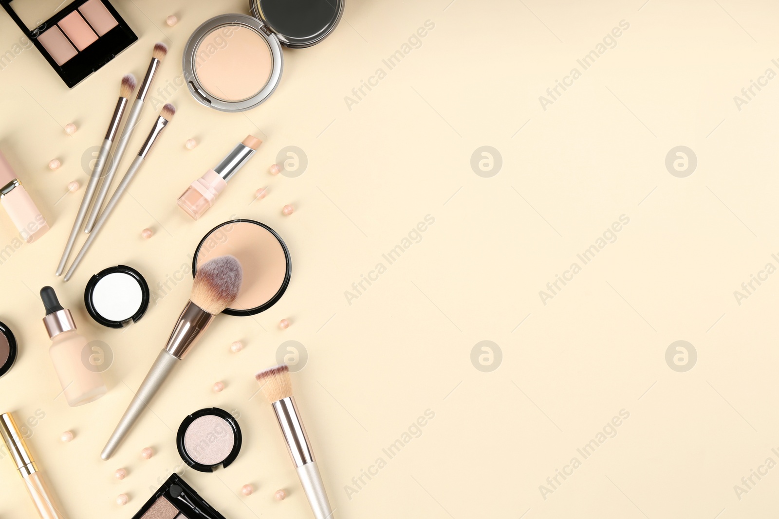 Photo of Flat lay composition with makeup brushes on beige background, space for text