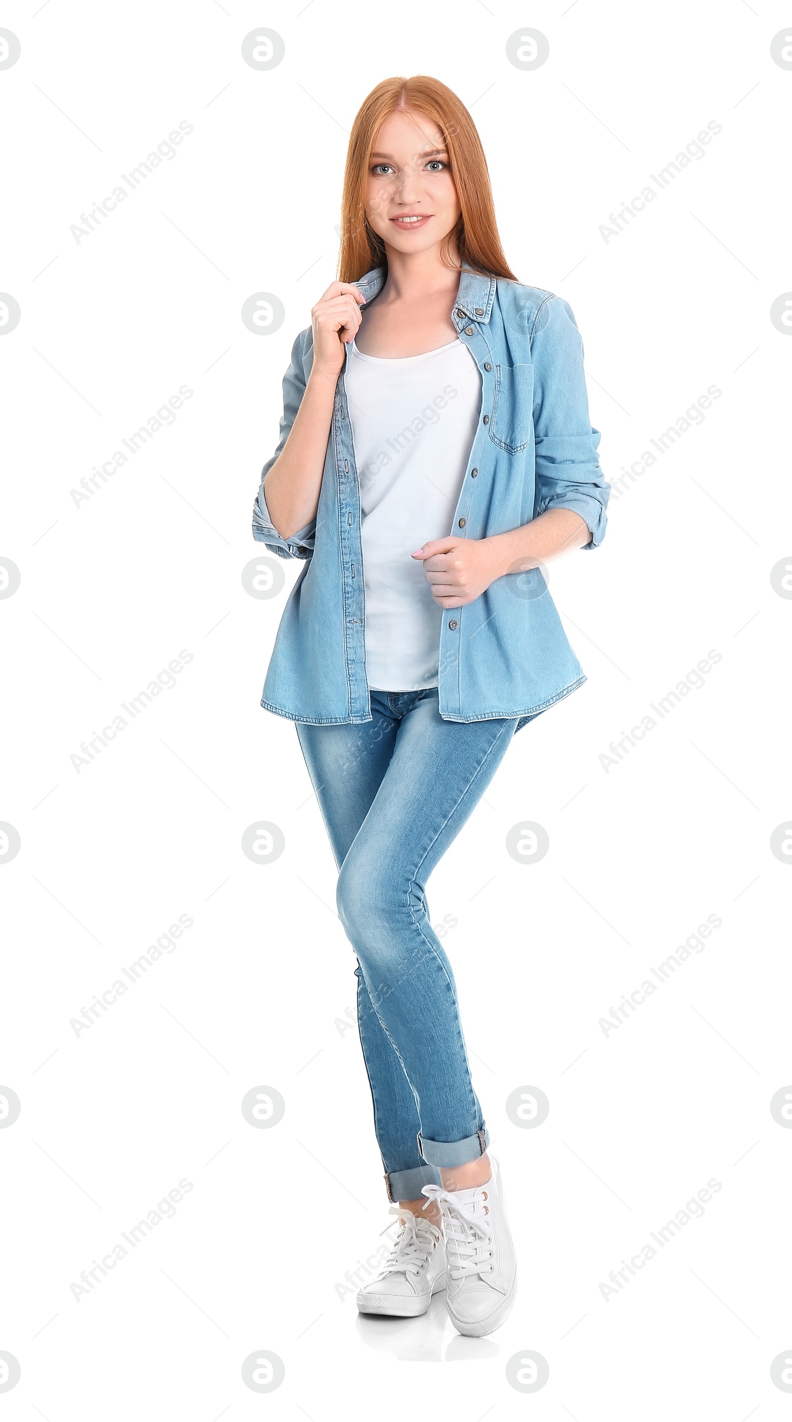 Photo of Young woman in stylish jeans on white background