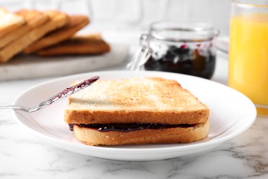 Image of Tasty sandwich with raspberry jam for breakfast on marble table