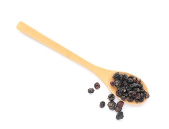 Dried black currants and wooden spoon isolated on white, top view