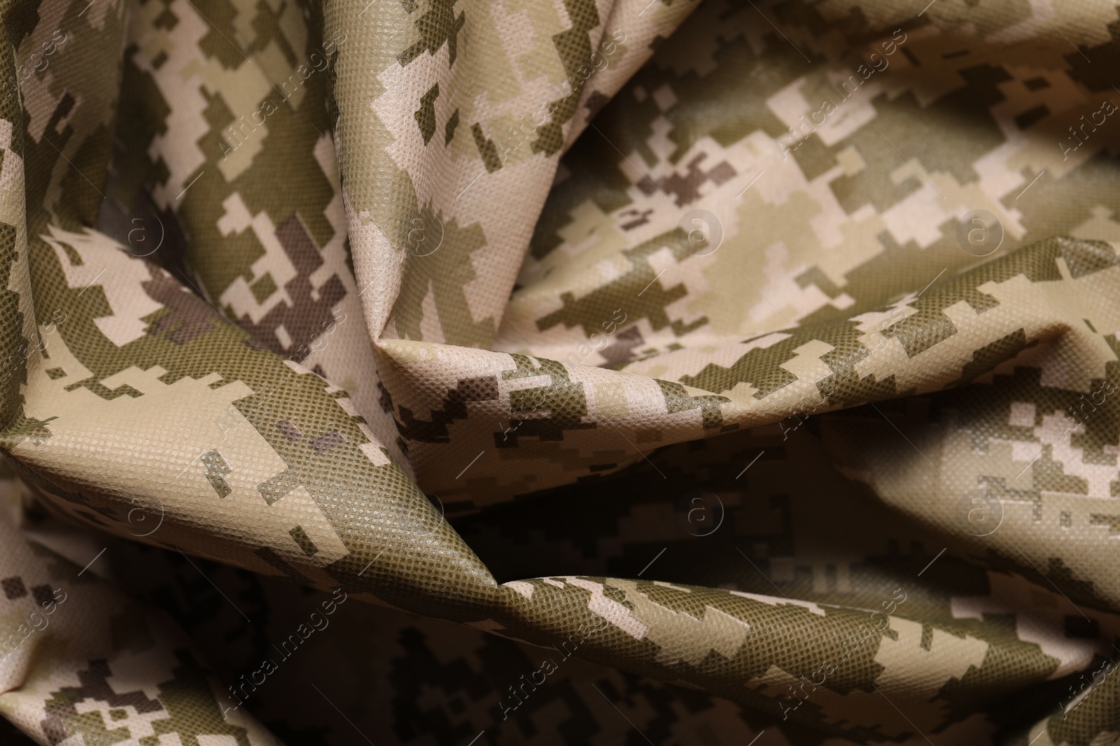 Photo of Texture of crumpled camouflage fabric as background, closeup