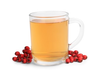 Photo of Cup with hawthorn tea and berries isolated on white